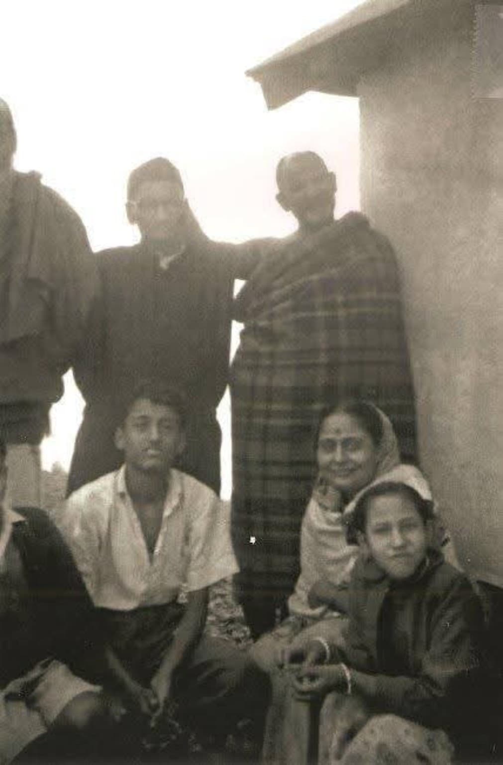 A young Rabboo Da with Maharajji in a black-and-white family photograph